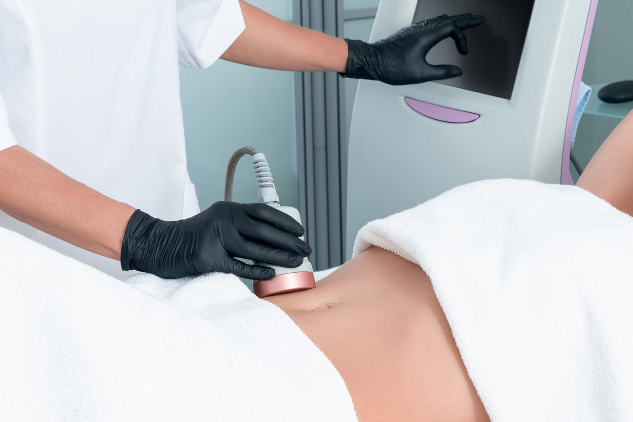Ultrasound cavitation body contouring treatment. Woman getting anti-cellulite and anti-fat therapy on her leg in beauty salon